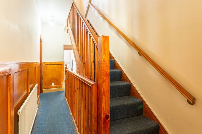 A Well-Maintained Staircase With Natural Wood Acce...