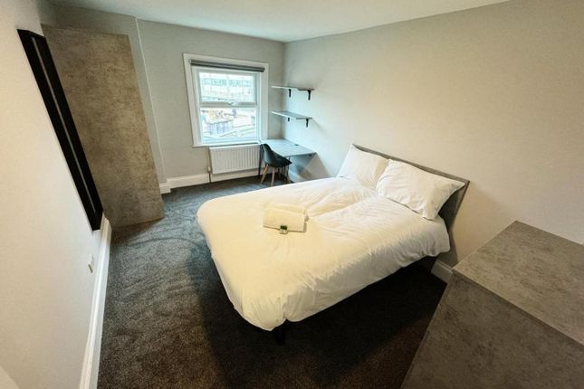 A Spacious And Well-Lit Double Bedroom With A Comf...