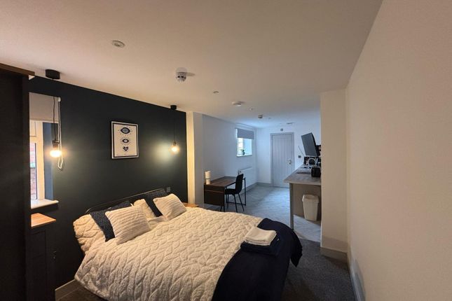 This Cozy Double Bedroom Features A Comfortable Be...