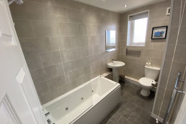 A Spacious And Modern Bathroom Featuring A Relaxin...