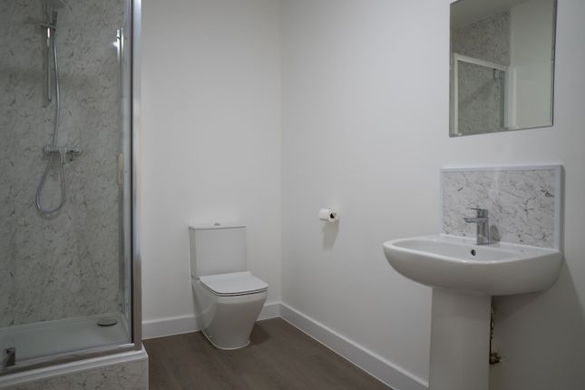 A Clean And Modern Bathroom Featuring A Shower, Si...