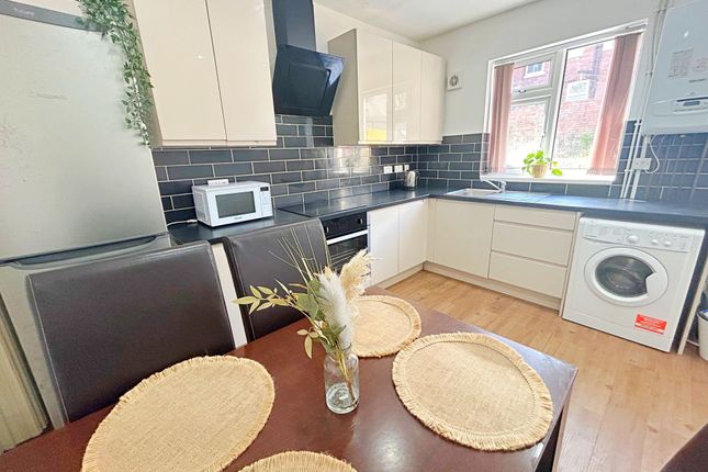 Bright And Modern Kitchen Featuring Cream Cabinetr...