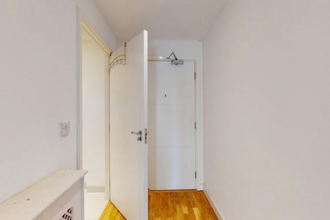 Bright And Clean Hallway Featuring Polished Wooden...