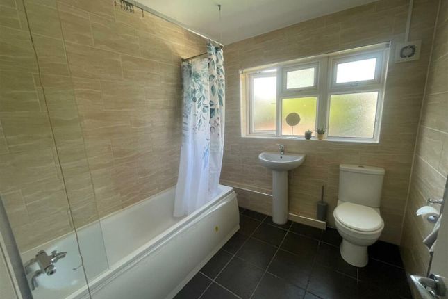 A Clean And Tidy Bathroom Featuring A Bath And Sho...
