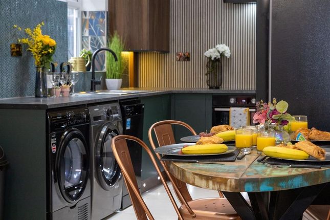 A Modern And Stylish Kitchen Featuring Sleek Black...