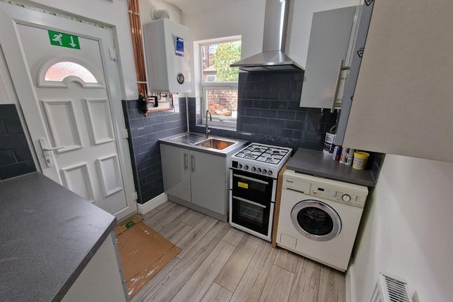 A Compact, Modern Kitchen Featuring Clean Countert...