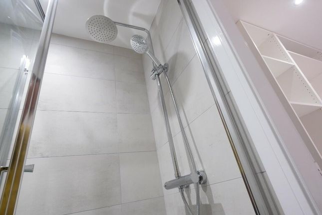 A Clean And Modern Bathroom With A Spacious Shower...