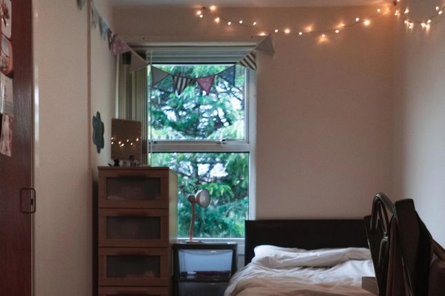 A Cozy Single Bedroom Featuring A Neatly Made Bed ...