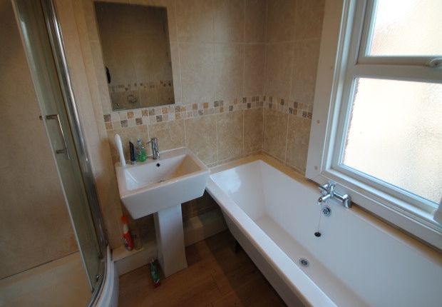 Bright And Clean Bathroom Featuring A Large Bathtu...