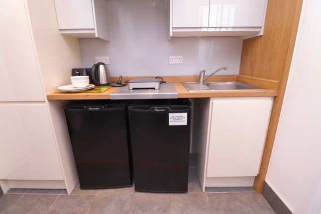 A Sleek And Tidy Kitchenette Featuring Modern Appl...