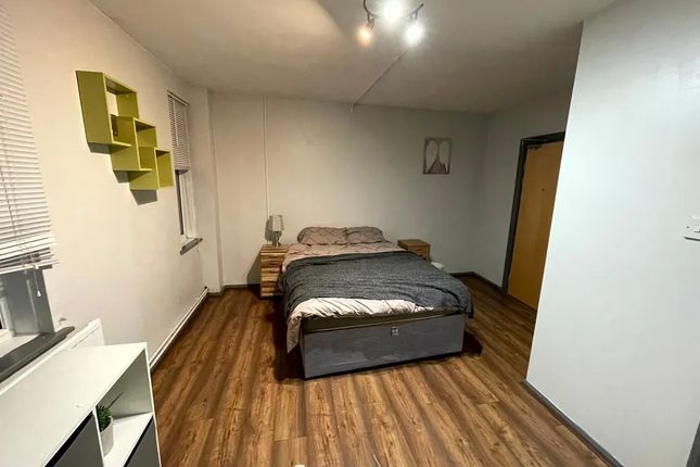 A Tidy And Spacious Double Bedroom With Warm Woode...