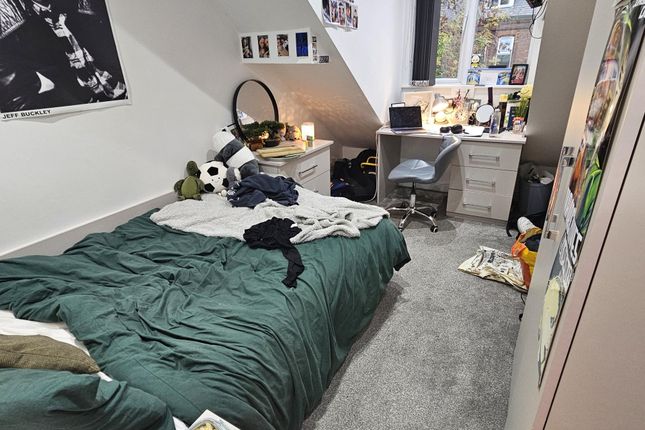 A Cozy Single Bedroom With A Neatly Made Bed, A Wo...