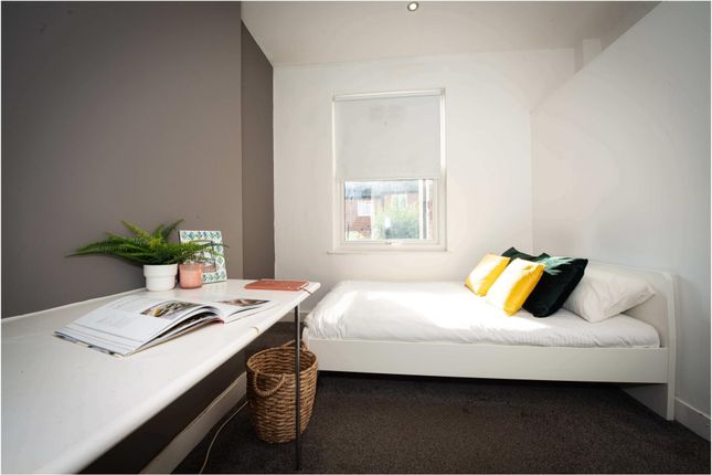A Bright And Tidy Single Bedroom With A Comfortabl...