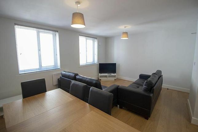Bright And Spacious Living Room Featuring Comforta...