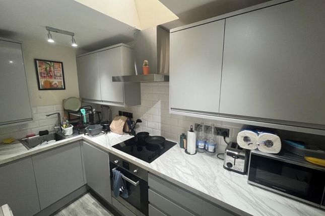 Bright And Modern Kitchen Featuring Sleek Grey Cab...