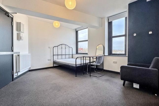 A Spacious, Well-Lit Living Room Featuring Large W...