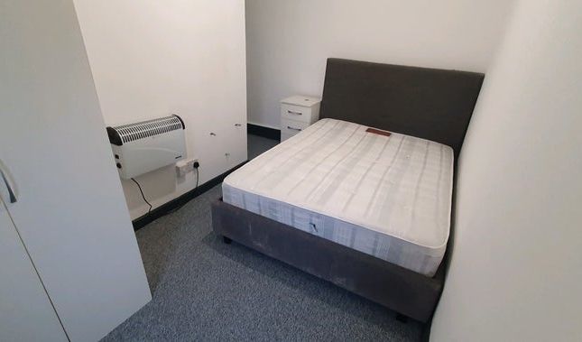A Compact And Tidy Bedroom Featuring A Double Bed ...