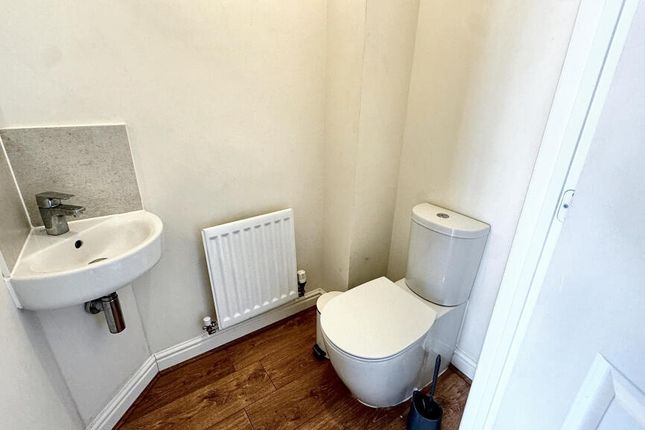 A Compact And Clean Single Toilet Room Featuring A...