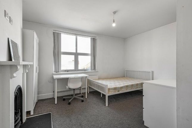 A Bright And Tidy Master Bedroom Featuring A Comfo...