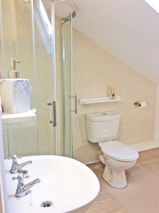 Bright, Well-Maintained Bathroom With A Corner Gla...