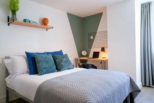 A Modern Double Bedroom Featuring Stylish Decor An...