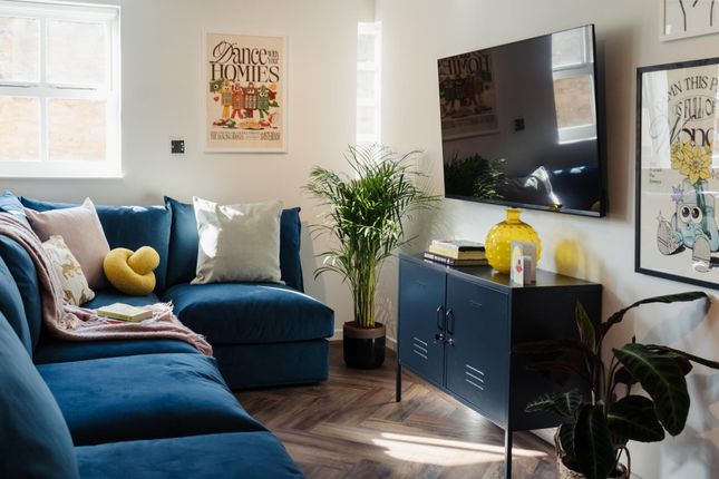 Bright And Stylish Living Room Featuring A Plush B...