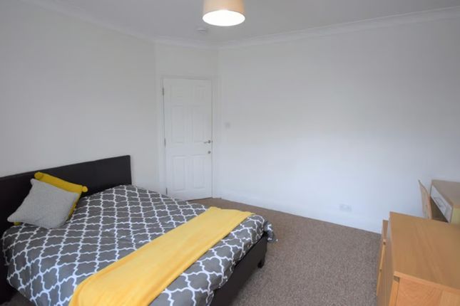 This Cozy Double Bedroom Features A Comfortable Be...
