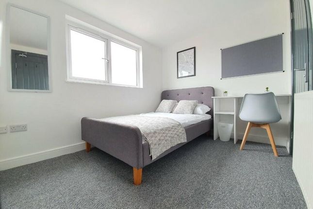 A Spacious, Well-Lit Master Bedroom Featuring A La...