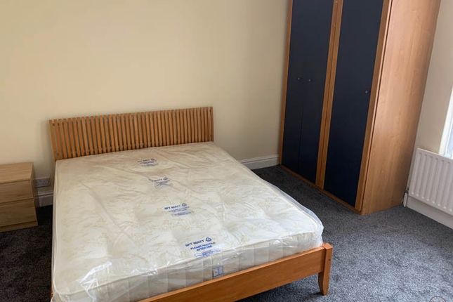 A Spacious Master Bedroom With Modern Furnishings,...