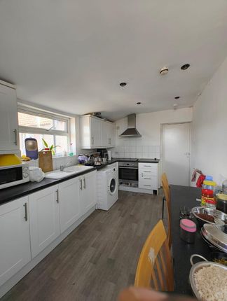 Bright And Functional Kitchen Featuring Ample Coun...