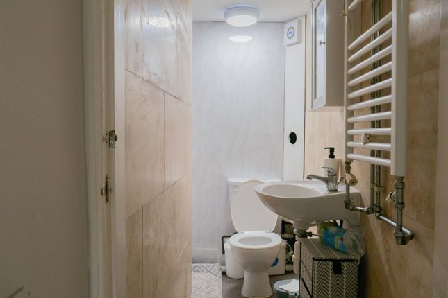 A Clean And Functional Bathroom Featuring A Toilet...