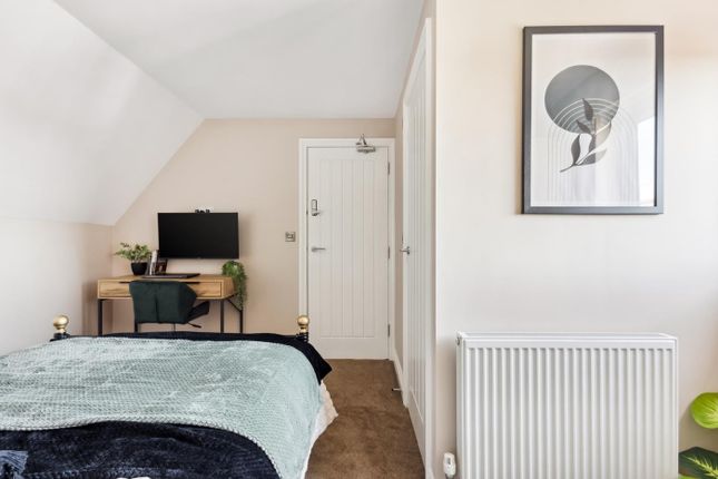 This Cozy Double Bedroom Features A Stylish Decor,...