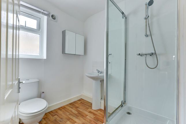 A Clean And Bright Bathroom With A Modern Shower E...