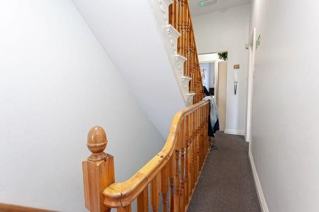 A Clean And Well-Maintained Hallway Featuring A Wo...