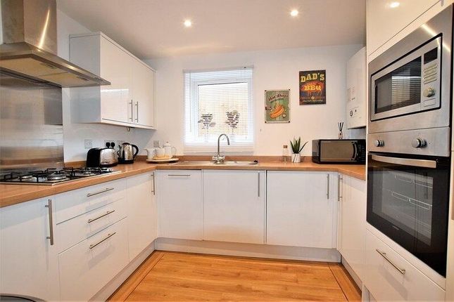 Bright And Modern Kitchen Featuring Sleek White Ca...