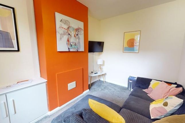 A Cozy Living Room With A Stylish Orange Fireplace...