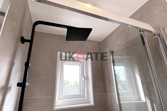 A Modern Bathroom Featuring A Sleek Walk-In Shower...