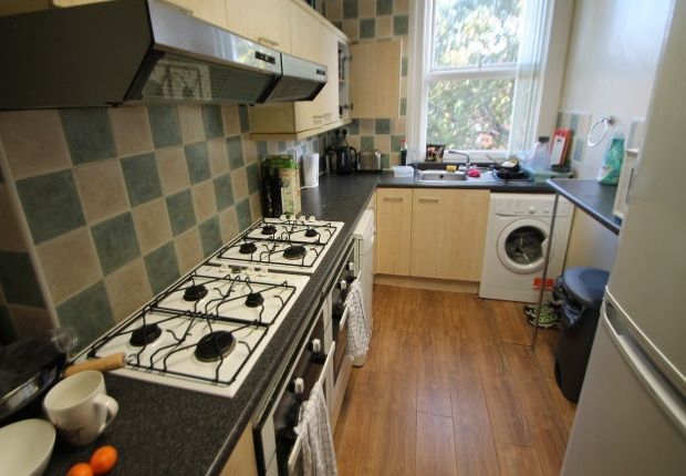 A Functional And Well-Lit Kitchen With A Gas Stove...
