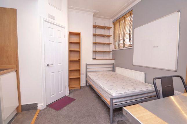 A Tidy And Well-Lit Double Bedroom Featuring Shelv...