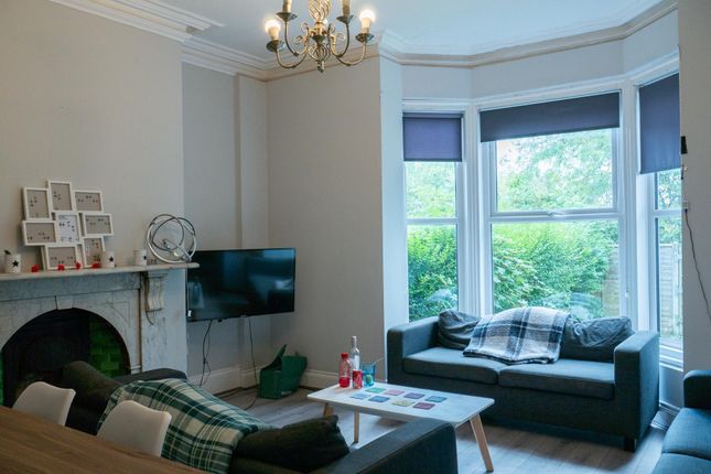 Bright And Spacious Living Room Featuring Large Wi...