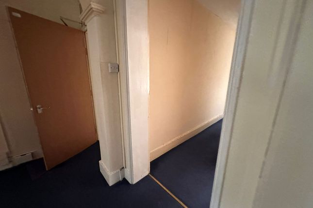 A Simple Hallway With Blue Carpet Flooring And Cre...