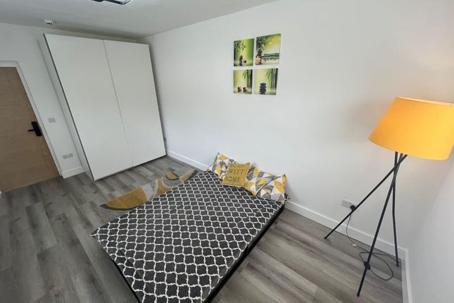 A Modern Double Bedroom Featuring A Comfortable Be...