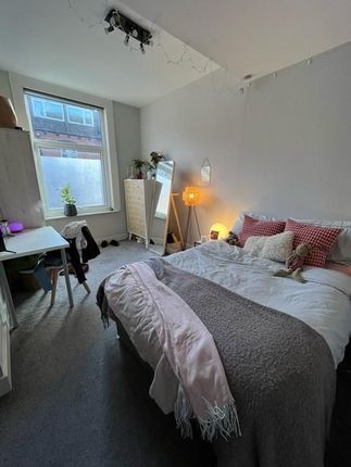 A Cozy And Welcoming Master Bedroom Featuring A La...