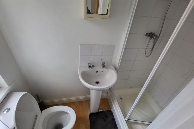 A Clean, Compact Bathroom Featuring A White Toilet...