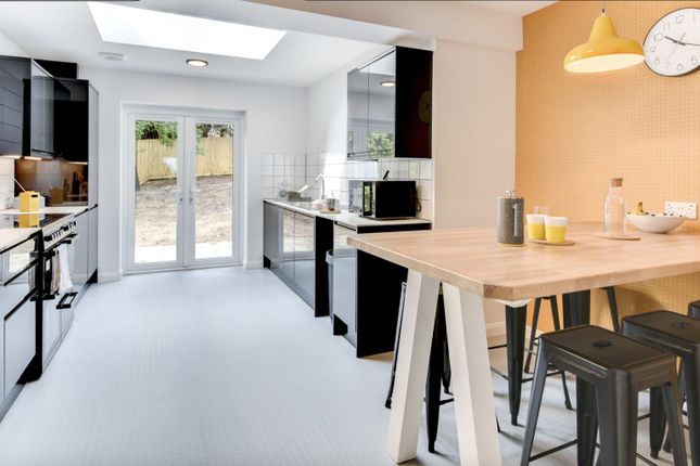This Modern Kitchen Features Sleek Black Cabinetry...
