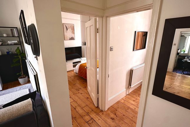 A Neat And Well-Maintained Hallway Leading To A Si...