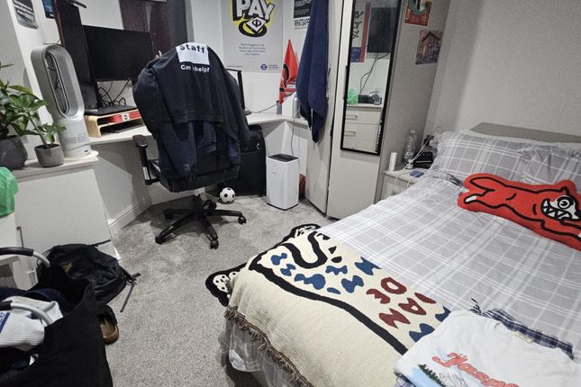 A Cozy Bedroom Featuring A Neatly Made Double Bed ...