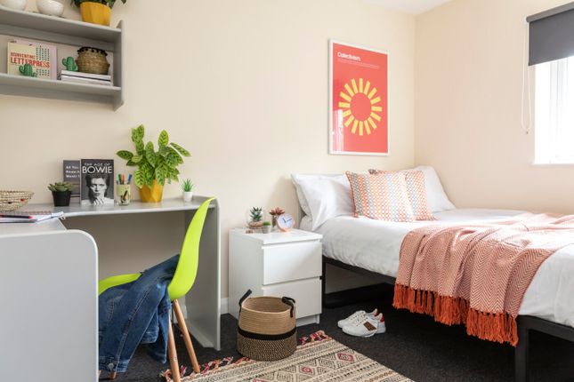 A Bright And Stylish Bedroom Featuring A Cozy Bed ...