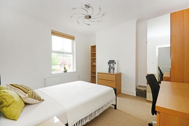 A Bright, Spacious Master Bedroom Featuring A Comf...