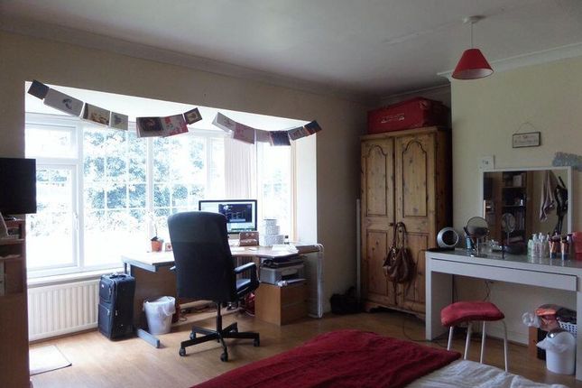 A Spacious And Well-Lit Living Room Featuring A Co...